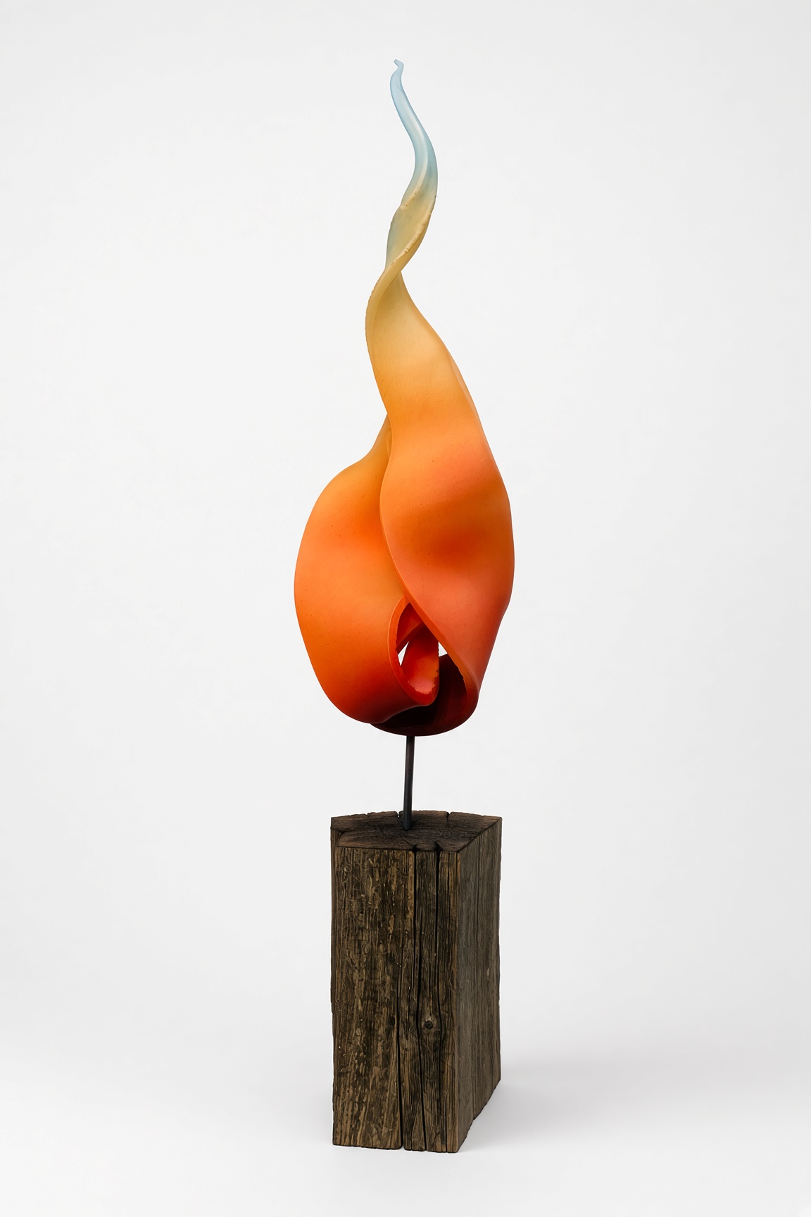 Twisting flame sculpture on a wood base