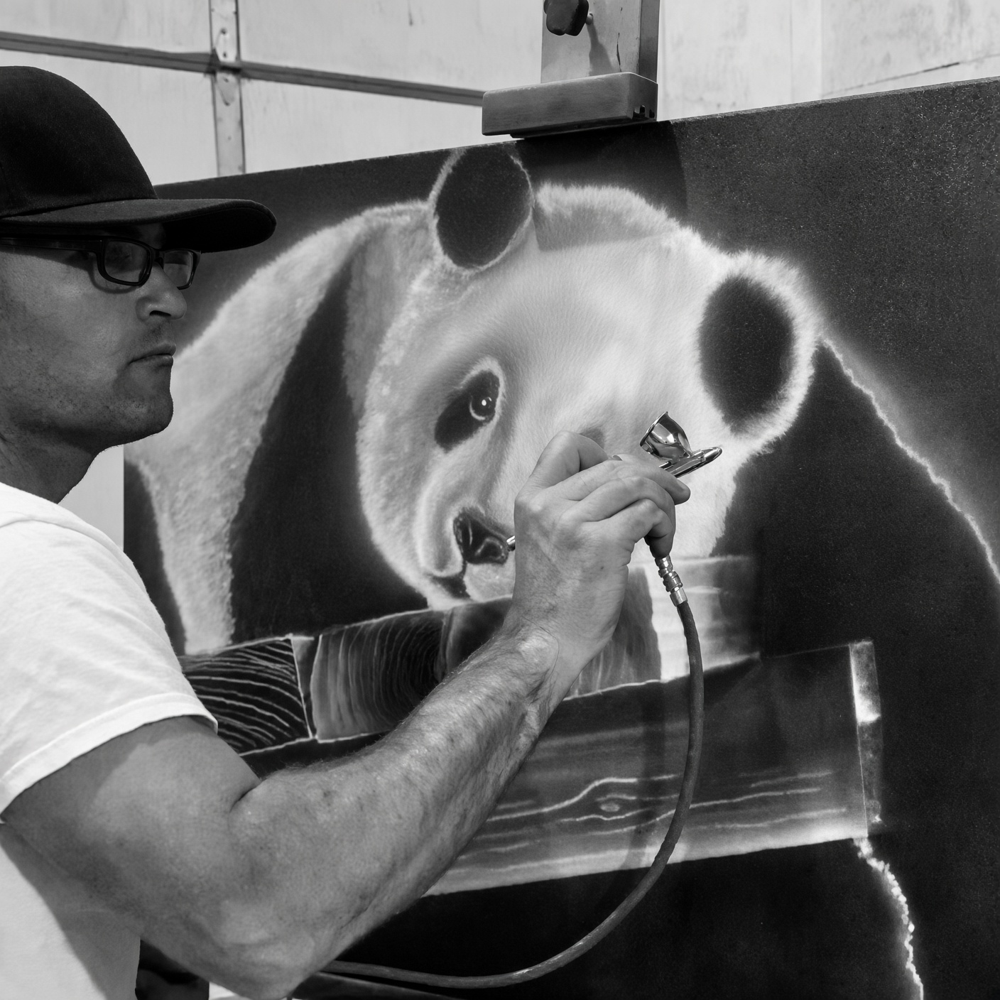 Airbrushing a panda painting in the studio